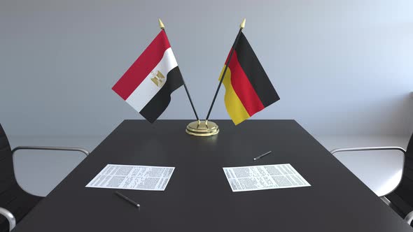 Flags of Egypt and Germany and Papers on the Table alt