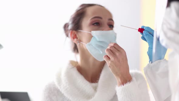 Nurse in Protective Suit Taking PCR Swab From Female Patient Nose  Movie Slow Motion