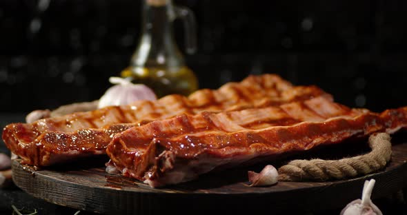 Raw Ribs Rotate Slowly on a Wooden Tray