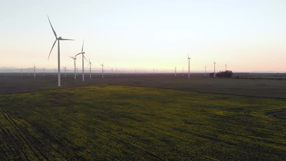 General view of wind turbines in countryside landscape with cloudless sky