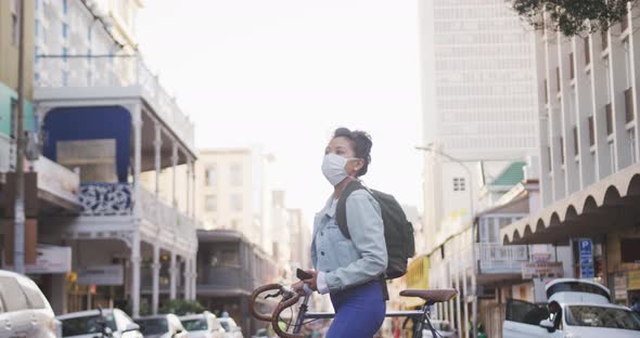 Woman wearing medical coronavirus mask walking on the street
