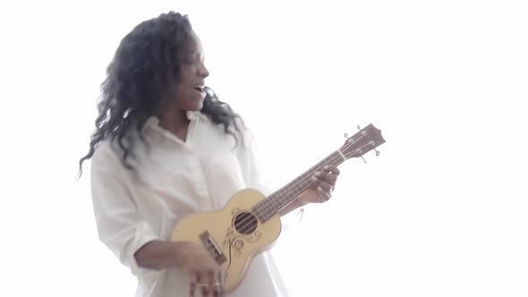 Isolated Woman Playing Ukelele Standing in White Background