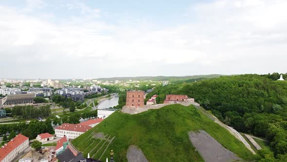 Gediminas Castle and Vilnius township, aerial ascend reveal shot