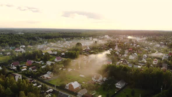 Aerial Shot of Beautiful Countryside Village in the Morning Sunlight, with Mist Floating on the Farm