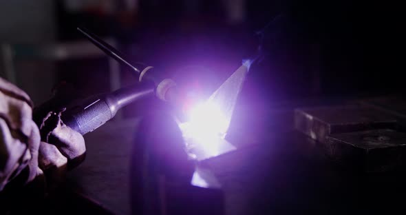 Welder welding a metal