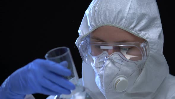Female Scientist in Uniform Showing Biohazardous Liquid in Flask, Chemical Lab