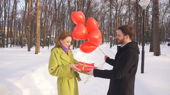 Young Man on a Date Gives His Beloved a Gift. Love Story
