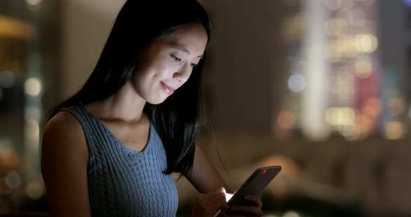 Woman use of smart phone at night 