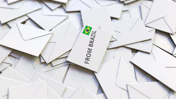 Envelope with From Brazil Text on Pile of Other Envelopes alt