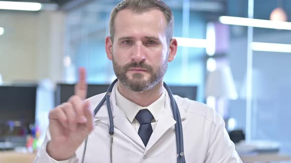 Portrait of Young Doctor Saying No with Finger Sign