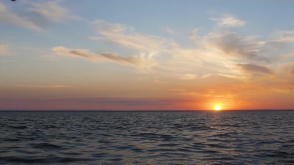 picturesque time-lapse of sunset on sea,sun hiding behind horizon of water