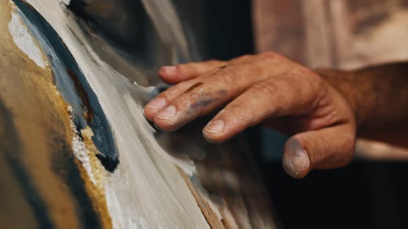 Painter Using His Hands To Creat an Oil Painting Masterpiece in Art Studio alt