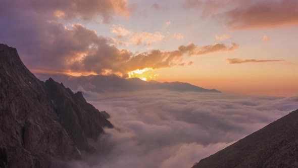 Mountains and Moving Clouds at Sunset. Aerial Hyper Lapse