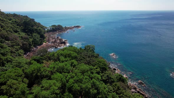 Aerial View of the Rocky Seashore of a Beautiful Bay with Clear and Transparent Water