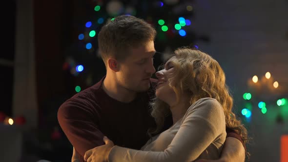 Newly Married Couple Kissing Tenderly Under X-Mas Tree, First Holiday Together