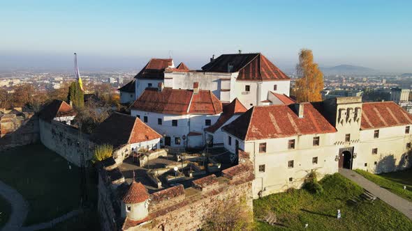 Aerial drone view of The Citadel in Brasov at sunrise, Romania. Medieval fortress on the top of a hi