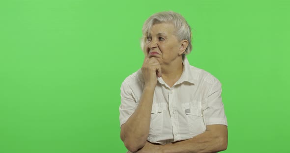 An Elderly Woman Thinks About Something. Old Thoughtful Grandmother. Chroma Key