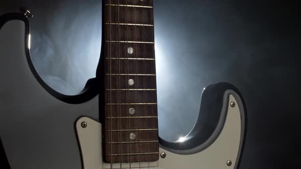 Close Up Shot of Electric Guitar. Soffits Light and Smoke on the Stage Before Concert
