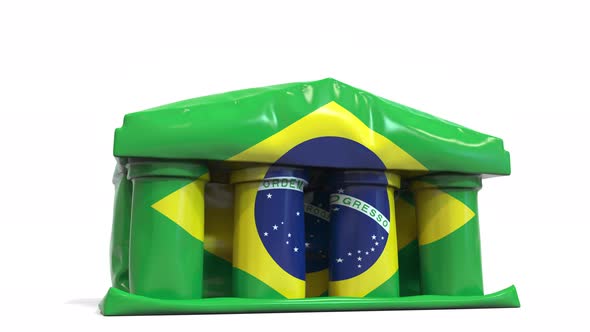 Deflating Inflatable Bank Building with Flag of Brazil