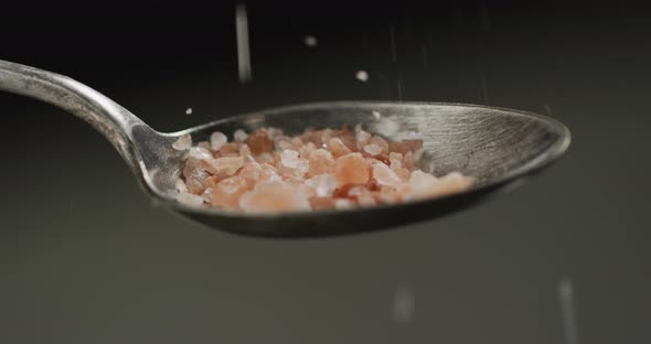 Video of cook throwing salt on the table on black background