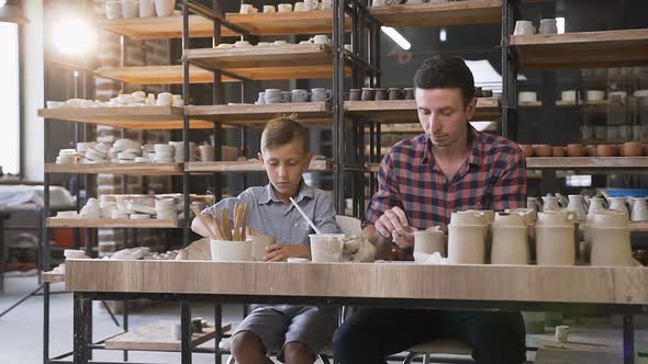 Middle Age Man with His Little Son Spending Time in the Pottery