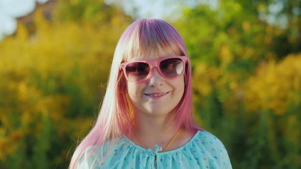 Portrait of a Girl with Pink Hair in Pink Sun Glasses