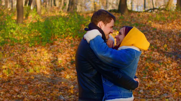 Happy Couple Embracing Outdoors in Autumn Forest