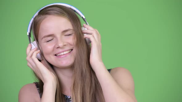 Young Happy Beautiful Woman Listening To Music