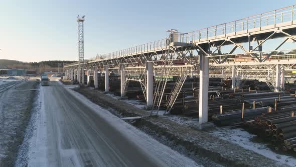 Drone view of Round metal pipes in Metal warehouse with railway access. 16