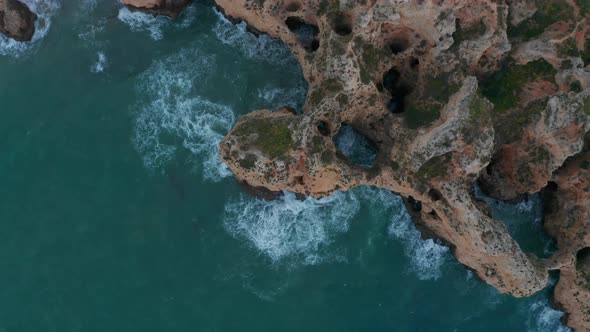 Aerial Birds Eye Overhead Top Down View of Scenic Lagos Colored Rocky Cliff Coast in Lagos Algarve