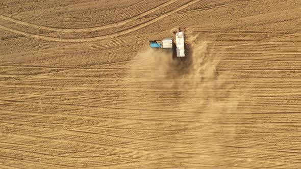 Aerial View Tractor With Seed Drill Machine Sowing Seeds For Crops In Spring Season