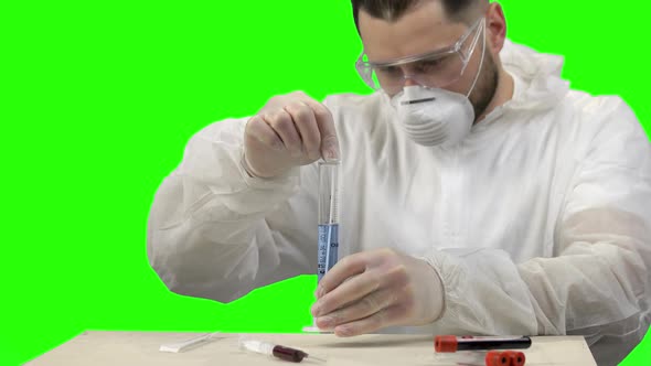 Young Scientist Stirring Blue Liquid in a Test Tube