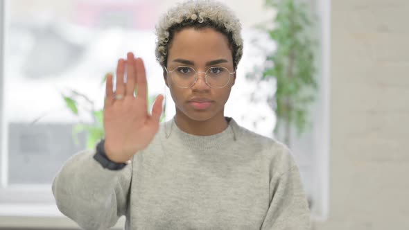 Portrait of African Woman Showing Stop Sign By Hand