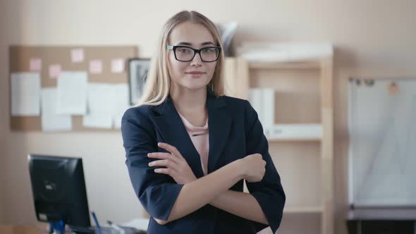 Portrait of a beautiful women entrepreneur standing in the office and smiling at the camera.