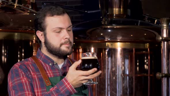 Beer Maker Drinking Delicious Dark Beer, Smiling To the Camera