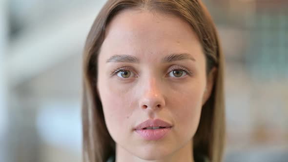 Close Up of Face of Serious Young Woman Looking at the Camera