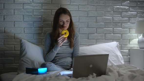 Depressed Girl Crying and Eating Donut to Overcome Stress, Watching Movie Alone