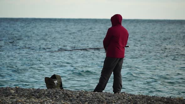Man Hobby Fishing on Sea Tightens a Fishing Line Reel of Fish Summer