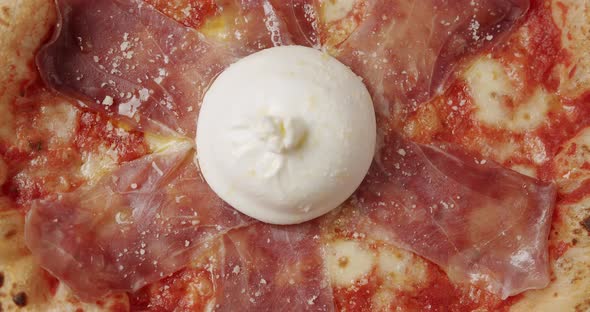 Rotating Prosciutto Pizza with Cheese on White Background