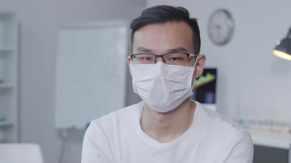 Sick Asian Man Looking at Camera alt