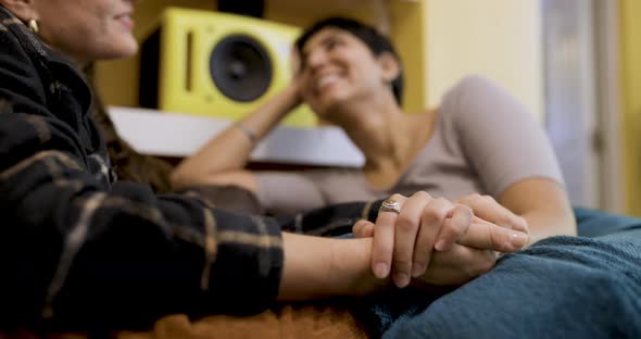 happy lesbian couple smiling and relaxing on the sofa