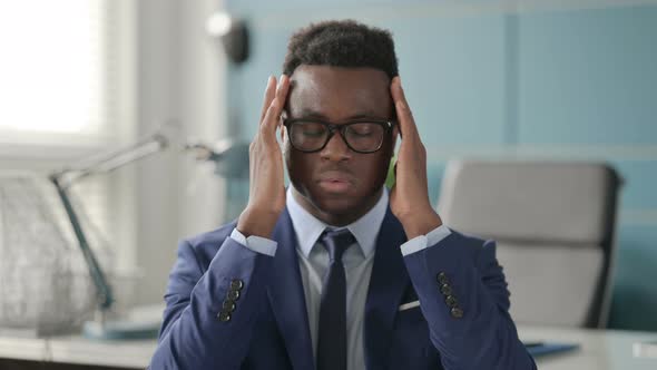 Portrait of African Businessman Having Headache