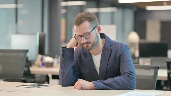 Tired Middle Aged Businessman Taking Nap While Sitting in Office