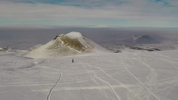 Snowboarders Ride on Top of a Mountain