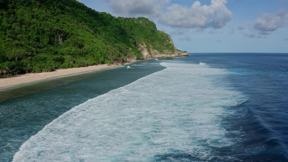 Aerial View of Ocean with Beautiful Foaming Rolling Waves, Mountain on Beach