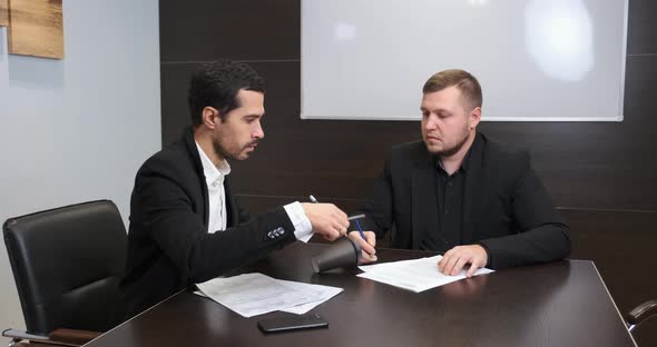 Office Worker Spills Coffee on the Table at the Meeting with His Boss