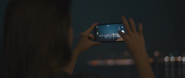 Woman zooms in to take photo of a city