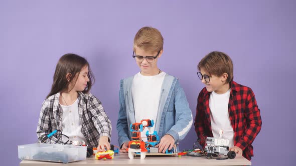 Caucasian Friends Kids Studying Engineering, Try To Assemble Robots. Science