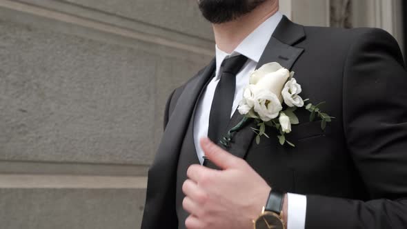 Close Up View of a Stylish Guy's Jacket and Wedding Boutonniere