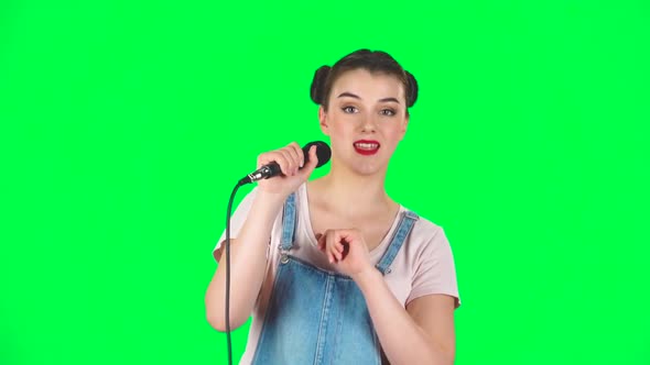 Attractive Girl Sings Into a Microphone and Moves To the Beat of Music, Slow Motion